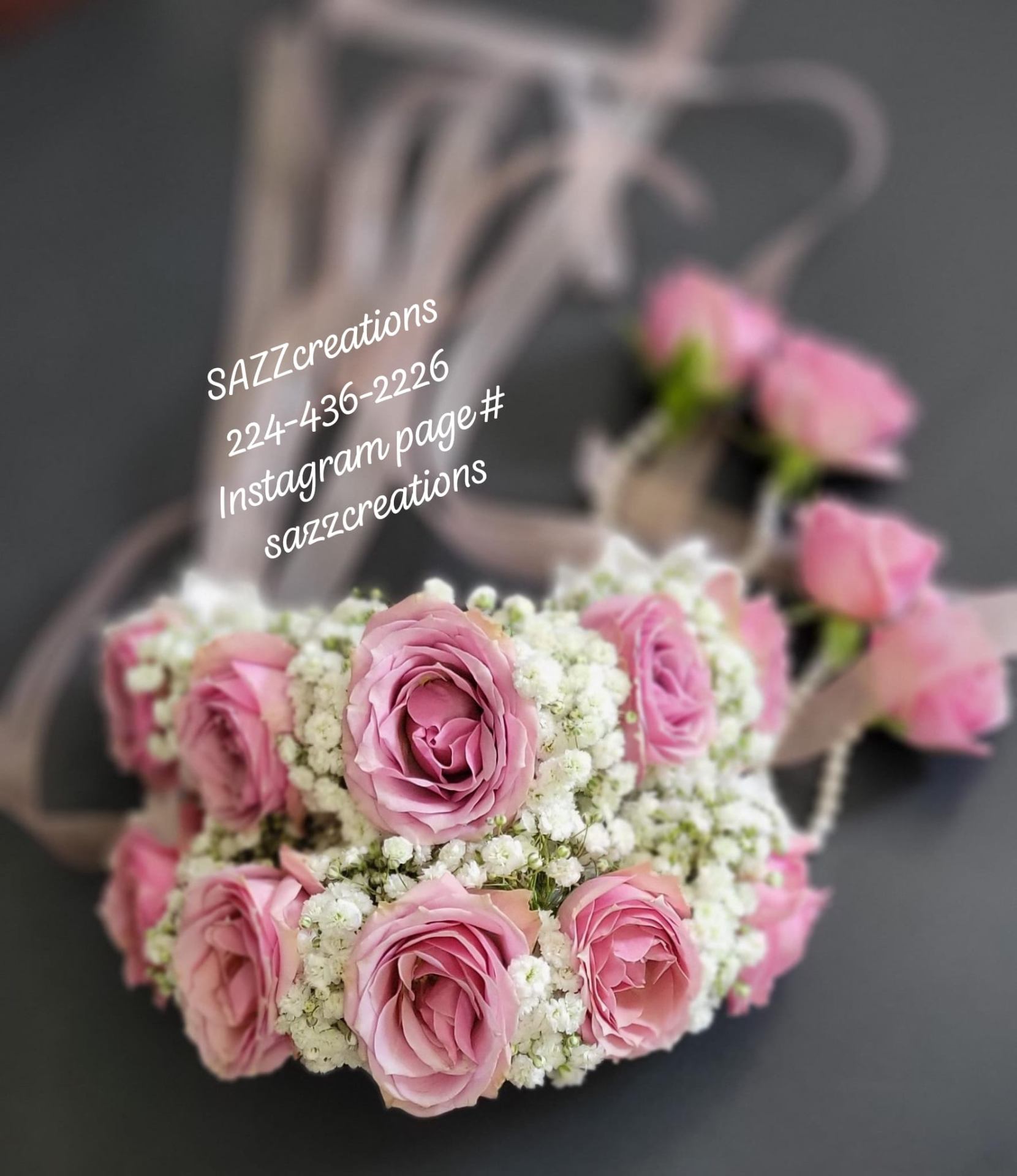 Pink rose and baby's breath garland handcrafted in a floral workshop